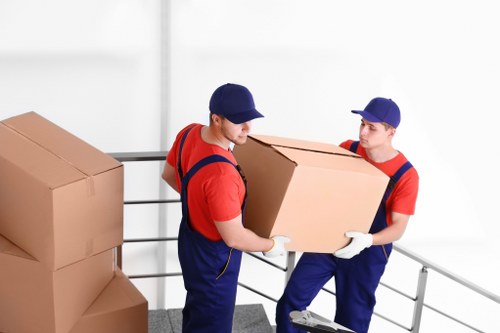Removalists transporting furniture from a flat in Palmers Green