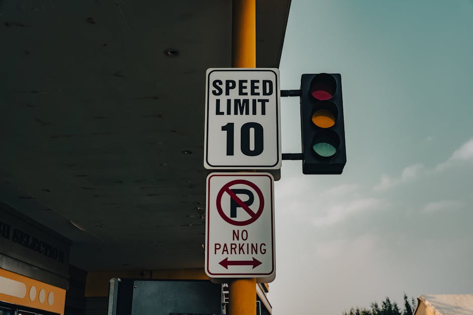 A close-up image of a green and white parking restriction sign mounted on a metal pole, with the background featuring a partly cloudy blue sky and blurred green foliage. The sign indicates a two-hour